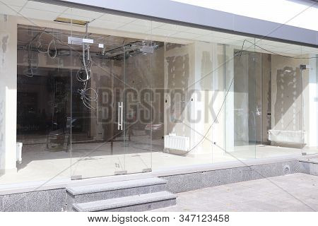 Repair Of A Modern Room With Glass Walls And Entrance Doors. Construction And Design Of A Trading Pl