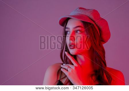 Close-up. Profile. Girl In Profile Biret Looks Into The Distance Color Filter Pink Background. Brune