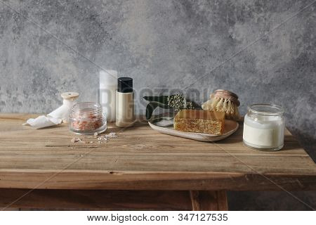 Still Life Of Organic Handmade Soap Bar, Wooden Brush, Moisturizer, Shampoo, Himalyan Salt And Eucal