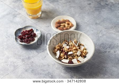 Bowl Of Granola With Nuts, Cranberry And Cocoanut. Concept For A Tasty And Healthy Meal. Stone / Woo
