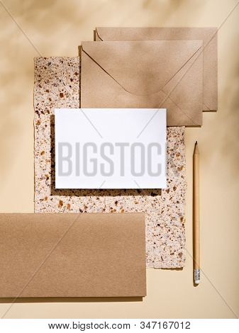 White Empty Paper Card With Stationery Set Of Envelopes, Notebooks, Pencil. Blank Card Styled Mockup