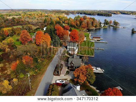 The Aerial View Of The Residential Area And Waterfront Homes Surrounded By Colorful Fall Foliage Nea