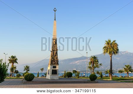 Turkey, Hatay - August 24, 2019: The Monument At Iskenderun With Trees And Mountains