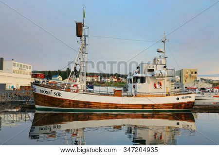 Husavik, Iceland - September 2019: Traditional old wooden fisherman boats used for whale watching in Husavik harbor