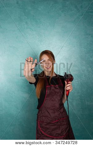 Smiling Girl Hairdresser Holds Fan And Scissors In Hands