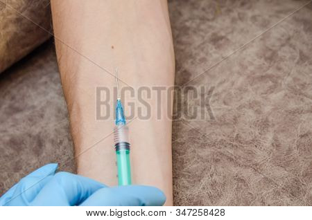 Female Doctor Conducts A Mantoux Test For A Man In A Clinic. Hand And Syringe Close-up