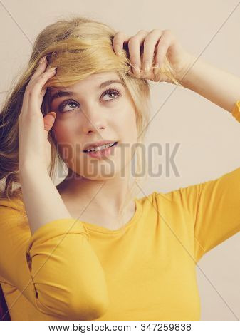 Girl Making A Fringe From Her Long Blonde Hair, Decided To Get Haircut. Hairstyle With Bangs. Hair C