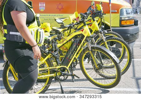 Yellow Car Ambulance And Ambulance Bicycles Magen David Adom With Text And Logoon The Street In Tel 