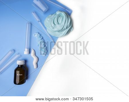 Components To Make Slime. Child Education Concept. On Blue Surface Slime, Toothpaste, Shaving Foam, 