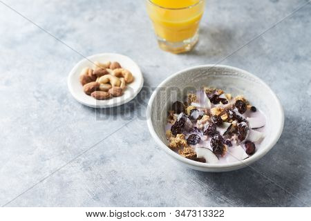 Bowl Of Granola With Yogurt, Nuts, Cranberry And Cocoanut. Concept For A Tasty And Healthy Meal. Sto