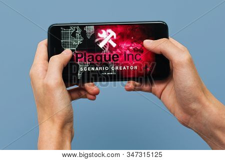 Samara, Russia -07, 29, 2019: A Young Guy Playing Plague Inc: Evolved Game On Iphone 8 Plus. Teenage