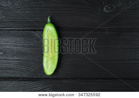Ripe Sliced Green Cucumber On A Black Wooden Background, Food