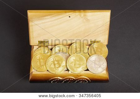Golden Bitcoin Coins In The Treasure Trove, Cryptocurrency In Wooden Chest, Gift, Decoration On Blac