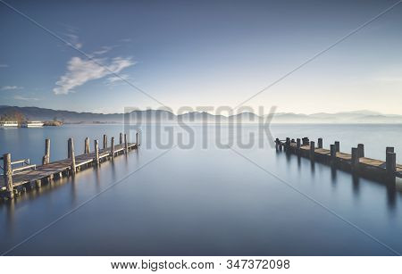 Two Wooden Piers Or Jetties And Lake At Sunrise. Torre Del Lago Puccini, Versilia, Massaciuccoli Lak