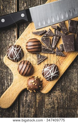 Praline bonbons. Chocolate truffles on curring board. Top view.