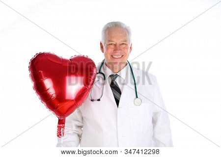 Valentines Day. Red Helium Heart Shape Balloon. A man in a suit holds a Red Heart Shaped Helium Balloon. Isolated on white. Room for text. Clipping Path.  Balloons are loved world wide. 