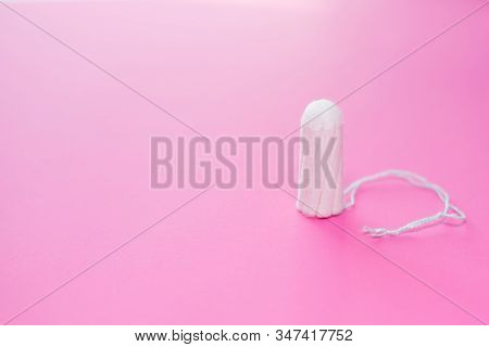 Medical Female Tampon On A Pink Background. Hygienic White Tampon For Women. Cotton Swab. Menstruati