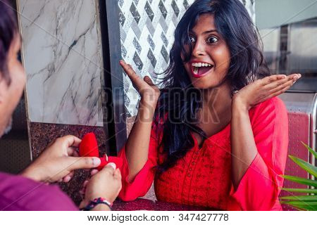 Amased And Surprised Indian Woman Feeling Happy To Get Proposal From Her Boyfriend In Restaurant. I 