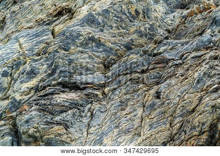 Black Cracked Rock On The Sea Shore