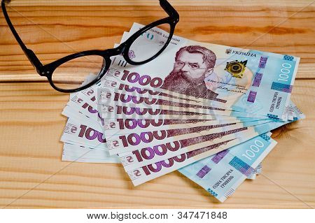Ukrainian Hryvnia, New Banknotes 1000 Hryvnia. Hryvnia Uah . Close-up Shot On A Wooden Background. F