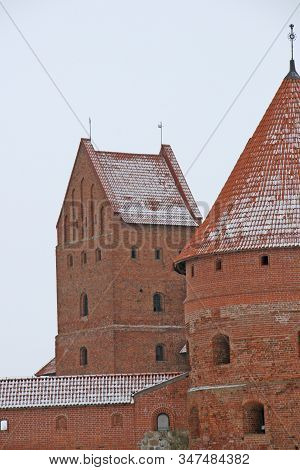Gothic Red Brick Trakai Castle In Winter Time, In The Middle Of Frozen Lake, Lithuania