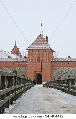 Gothic Red Brick Trakai Castle In Winter Time, In The Middle Of Frozen Lake, Lithuania