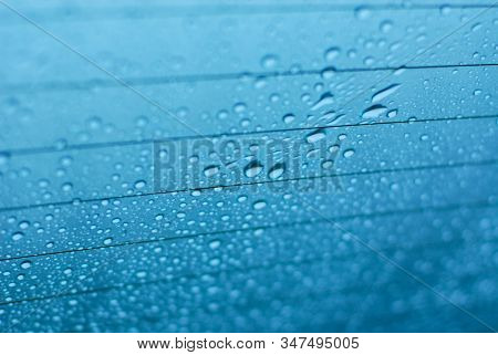 Water Drops On Glass Window With Blue Background