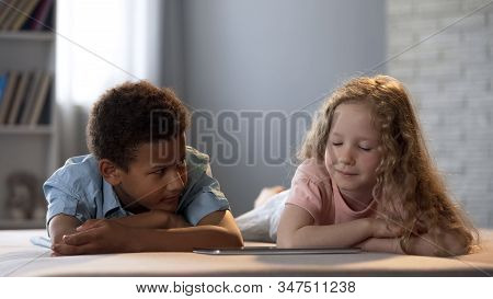 Afro-american Boy Shyly Looking At Pretty Girl While Watching Show Together