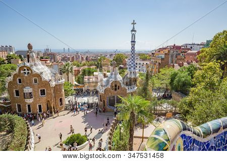 Barcelona, Spain - october, 2019: walking Barcelona city streets. Famous Park Guell in Barcelona, Spain. View of Gaudi Pavilion Houses at the entrance of the park.