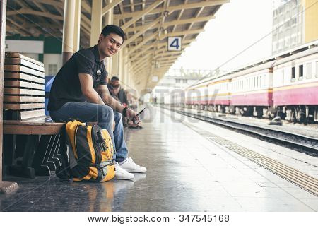 Cheap Travel And Lifestyle Concept.holiday Time,young Solo Traveler Man Wearing Sneaker And Sitting 