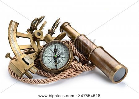 vintage still life with compass,sextant and spyglass isolated on white background