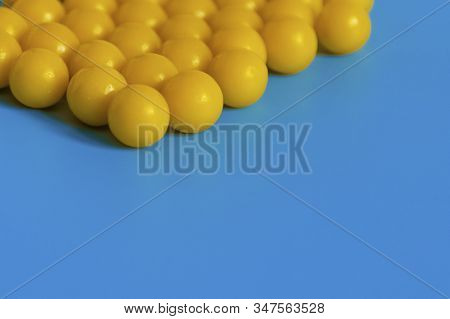Yellow Vitamins On A Blue Background. Vitamin Complex Against The Virus. Multivitamins To Enhance He