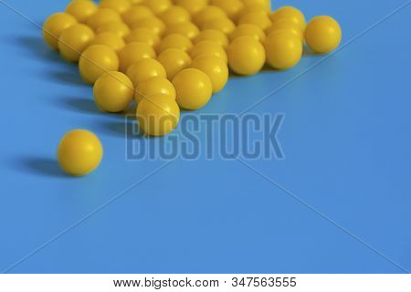 Yellow Vitamins On A Blue Background. Vitamin Complex Against The Virus. Multivitamins To Enhance He
