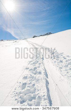 Spectacular Winter Mountain View With Ski Trail Ascending A Slope.