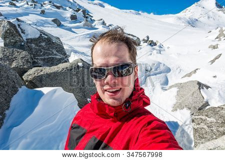 Male Mountaineering Taking A Selfie High In The Mountains.