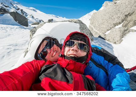 Happy Couple Posing On A Skiing Trip To The Mountains.