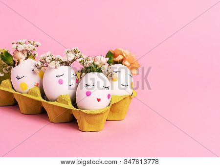 Easter Creative Concept. Easter Decorative Eggs With Painted Cheerful Faces And Flowers Instead Of H