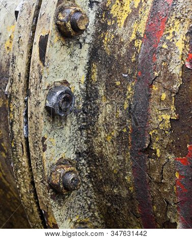 Bolt Coupling On The Old Metal Pipe (tube). Pipeline. Cracked And Damaged Yellow And Red Paint On Th