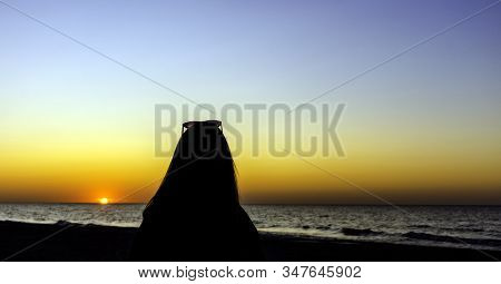 Silhouette Of A Girl With Sunset Over Baltic Sea In Lubiatowo, Pomerania, Poland