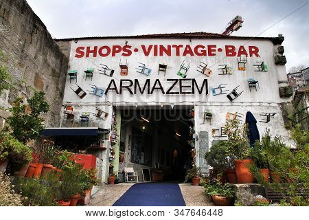 Porto, Portugal- January 3, 2020: Old Warehouse Facade With Chairs Called Armazem With Various Antiq