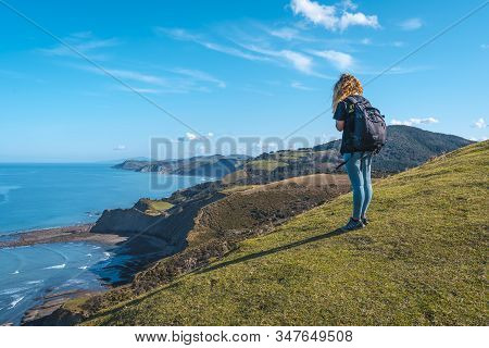 Deba, Gipuzkoa / Spain »; January 26, 2020: A Young Woman From The Viewpoint Watching The Sakoneta G