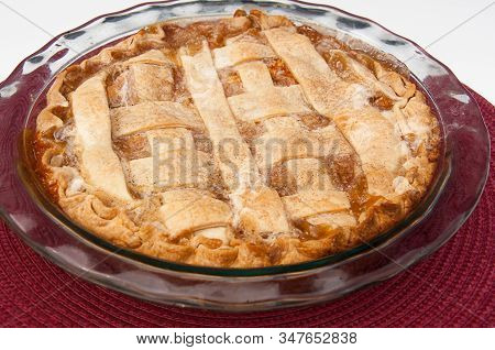 Hot Peach Pie Fresh Out Of The Oven.  Homemade Steaming Hot Baked Goods In A Glass Pie Pan, Made Wit