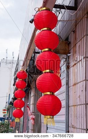 China, Heihe, July 2019: Red Chinese Lanterns On Buildings, Streets Of The Chinese City Of Heihe In