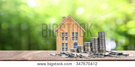 Growing Coins  House On Stack Coins. Concept Of Investment Propert And Finance Investment Concep