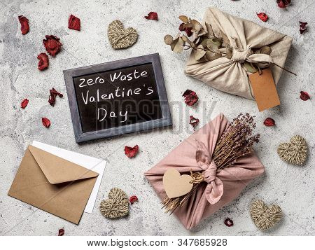 Zero Waste Valentines Day Concept. Eco-friendly Gift Cloth Wrapping In Furoshiki Style And Chalkboar