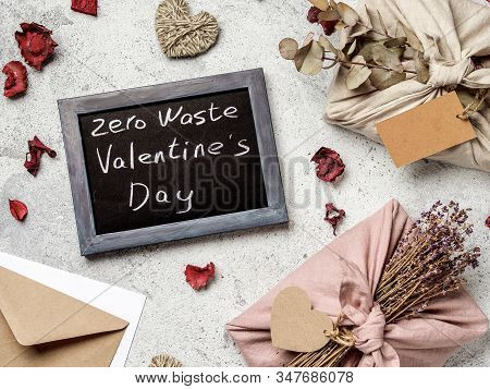Zero Waste Valentines Day Concept. Eco-friendly Gift Cloth Wrapping In Furoshiki Style And Chalkboar
