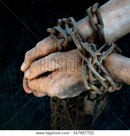 Hands Of A Humble Slave Who Is Not Trying To Free Himself Against A Dark Background, The Concept Of 