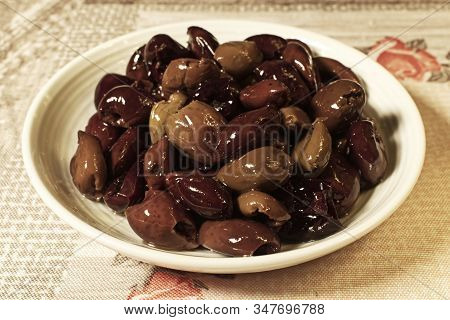 A Bowl Full Of Ligurian Taggiasche Olives On Wooden Background
