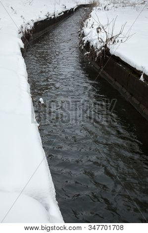 Urban Stream In Winter. The Lybid River (kyiv, Ukraine) In The Snow.