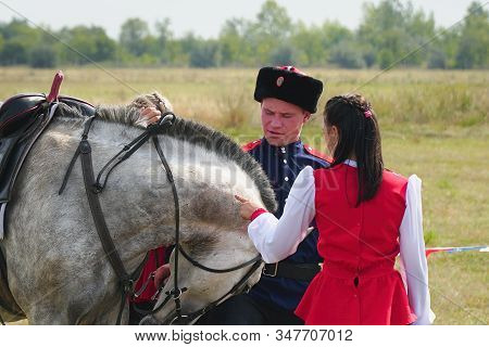 Samara, Russia - October 07, 2019: Young Cossack And Cossack Girl In National Costumes Standing Next